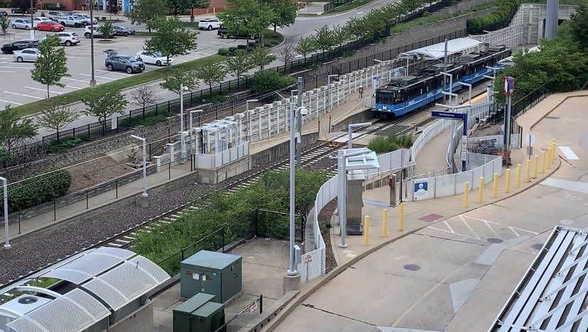 Brentwood I-64 Transit Center with a blue MetroLink train leaving the station